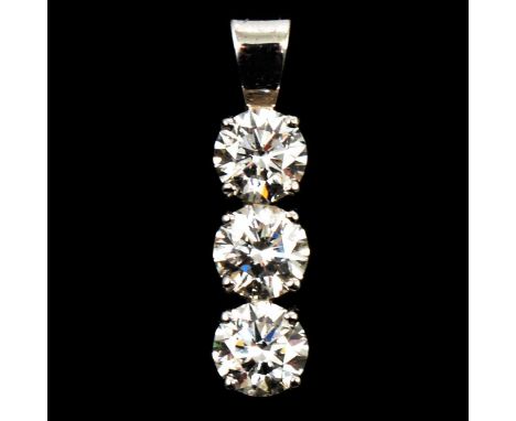 A diamond three stone pendant, the brilliant cut stones individually four claw set vertically in an all white metal mount, 22