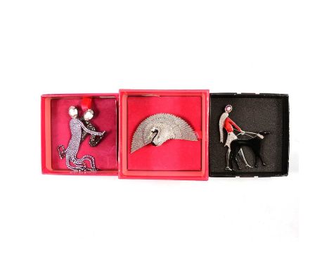 Three Butler &amp; Wilson crystal brooches in branded boxes, a 10cm fanned wing swan; a 12cm 1920's style couple ballroom dan