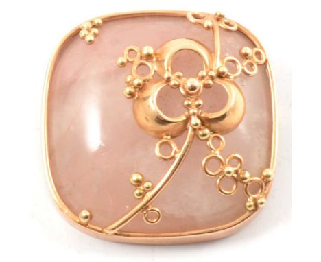 A rose quartz brooch, the 30mm square cabochon cut stone collet set in a yellow metal frame marked 585, a trefoil leaf and be