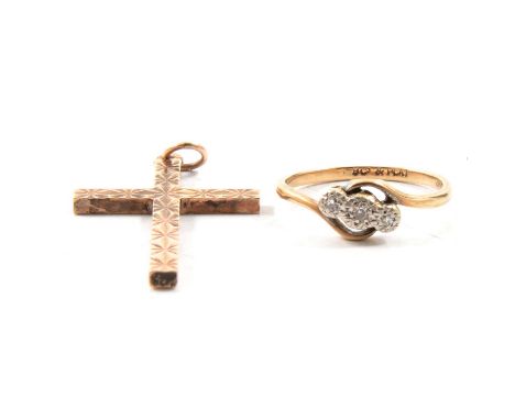 A 9 carat yellow gold cross, 33x20mm, diamond cut design, 3.3g; a diamond three stone ring, the 8 cut stones illusion set in 