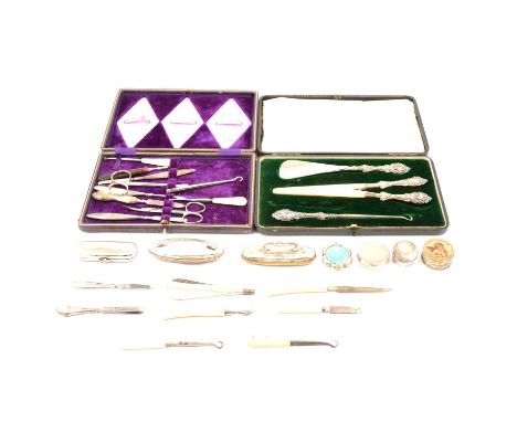 Silver manicure items in a fitted case missing some items; another case with silver handled button hook, shoe horn and glove 