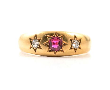 A diamond and ruby coloured three stone ring, two old cut diamonds and an untested ruby coloured stone, star gypsy set in an 