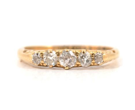 A diamond five stone ring, the old cut stones graduating in size claw set in an 18 carat yellow gold carved claw mount ring s