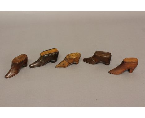 FOUR ASSORTED 19TH CENTURY TREEN SNUFF BOXES, in the form of heeled shoes, all with sliding covers and brass pin decoration, 