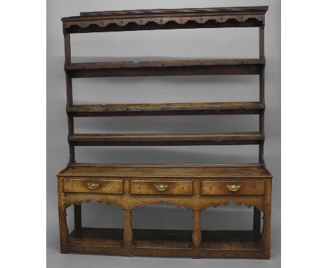 A MID 18TH CENTURY OAK WELSH DRESSER OF MONTGOMERYSHIRE TYPE, the three shelf plate rack on a base with three frieze drawers 