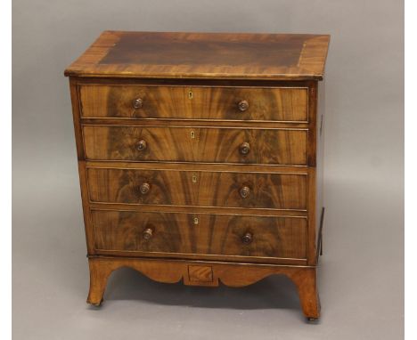 A GEORGE III MAHOGANY COMMODE, the cross-banded top above four faux drawers, lifting to reveal the commode interior with blue
