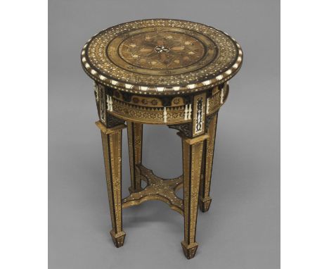 A MOORISH INLAID CIRCULAR SIDE TABLE, profusely inlaid with geometric patterns, the frieze set with bone spindles in an archi