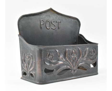 An early 20th century Art Nouveau Keswick style hammered copper letter through. The postbox with relief floral Nouveau design