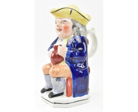 A believed late George III early 19th century Staffordshire pottery toby jug with lid. The jug depicting character with warty