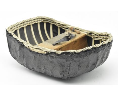 A mid 20th century 1957 Welsh presentation model coracle boat, presented to Megan Lloyd George M.P.. The coracle of strung wi