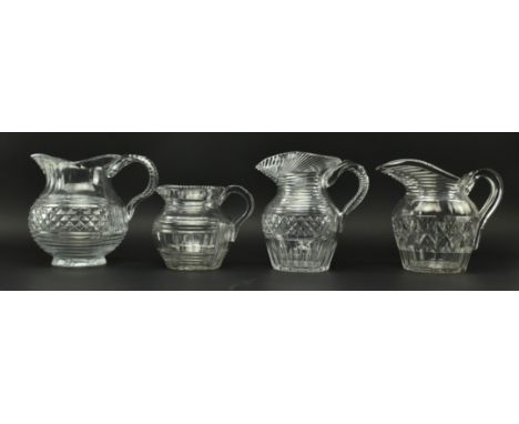 Four early 19th century cut glass jugs, each with stepped design and dogtooth rim. Each jug featuring step cut spout, two fea