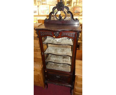 A circa 1900 Chippendale Revival mahogany single door bevelled glazed china display cabinet, having a fret carved shaped top,