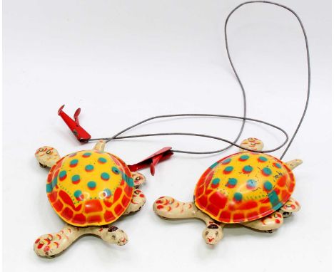 A pair of Mobo Toys 1950's tinplate Toy-Toise comprising a tinplate printed shell &amp; legs, with a hand-held wired controll