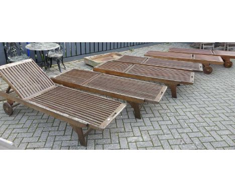 A set of six contemporary stained and slatted teak sun loungers, having adjustable ratchet mechanisms, each length 200cm 