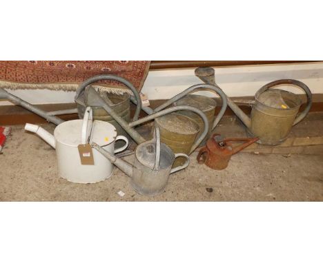 Six various galvanised metal watering cans; together with an enamel example (7)