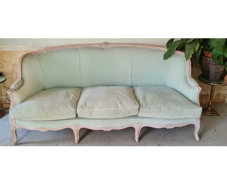 A French limed beech framed three-seater sofa, pale green plush fabric upholstered with squab cushions, width 190cmFrame is i