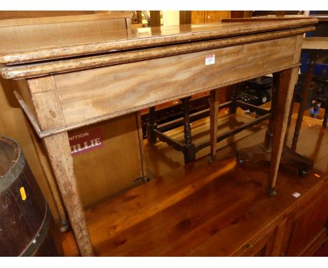 An early 19th century mahogany fold-over tea table, having rear gate leg action and raised on tapering supports, width 91.5cm