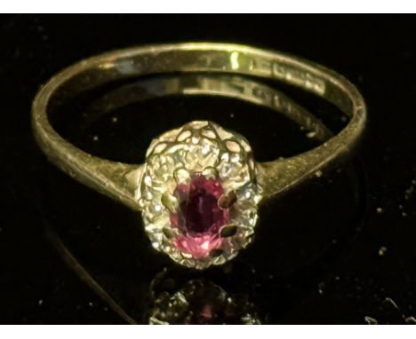9ct Gold ring set with central ruby surrounded by white stones Weight 1.5g Size K 