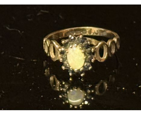 9ct Gold ring set with central opal surrounded by sapphires Weight 1.7g Size L 