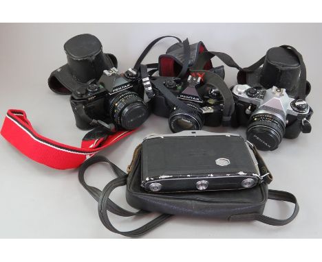 A group of cameras and accessories. To include: a Zeiss Icon, a Pentax ME Super, two Pentax MVs, a Kodak Easy Share Z740 and 