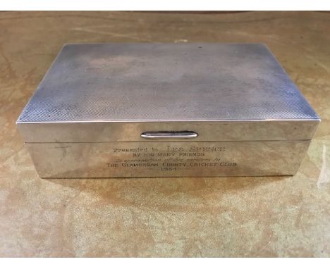 A George VI silver table cigarette casket of cricket interest, inscription presented to Les Spence, Glamorgan Country Cricket