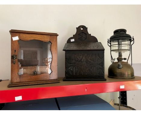 An Edwardian oak smoker's cabinet, an oak wall mounted casket and a Tilley lamp (3)