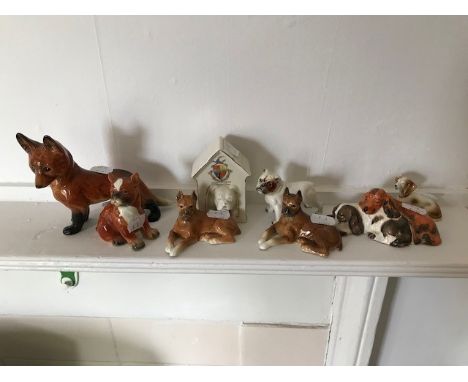 Six Goebel Models of dogs, a fox, and a crested porcelain dog in a kennel (6)