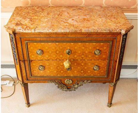 An Italian neoclassical kingwood parquetry and gilt metal mounted marble-topped commode, 19th Century, the canted pink-veined