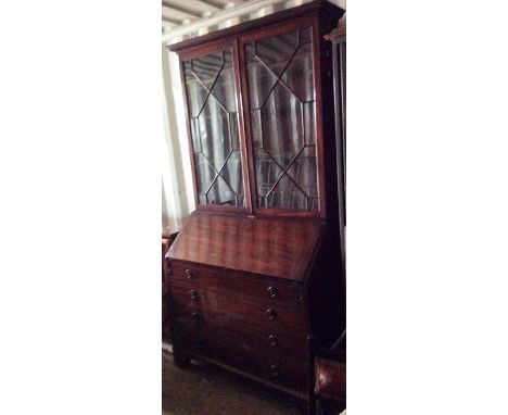 A George III mahogany bureau bookcase, circa 1780, the cabinet enclosing three adjustable shelves, the fall front enclosing d