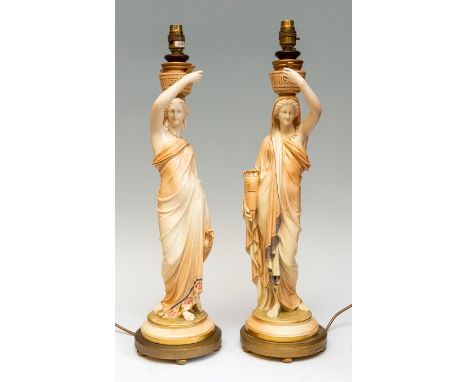 A pair of Royal Worcester blush ivory figural table lamps, in the form of a woman with two vases, 60cm high, (2)