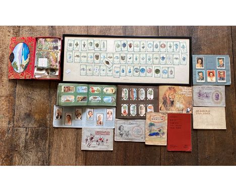 A cigarette card collection loose in a frame and albums.&nbsp;