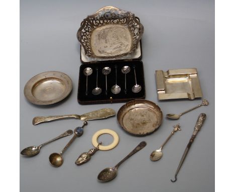 A mixed lot of small silver to include a pierced dish, engine turned ashtray, pin dishes, baby's rattle/teether, cased set of
