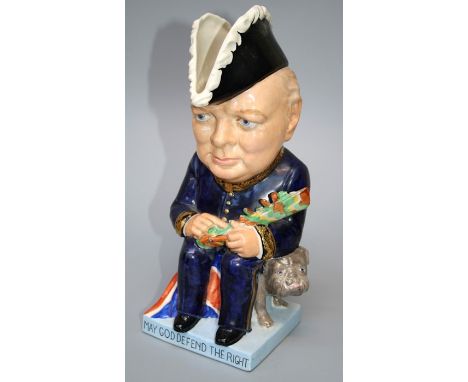 A limited edition Wilkinson, Clarice Cliff Winston Churchill character jug. Modelled seated with camoflaged battleship and bu