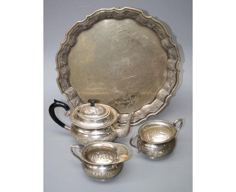 An early to mid 20th century Indian silver four piece tea service. The pie crust tray with presentation inscription and each 