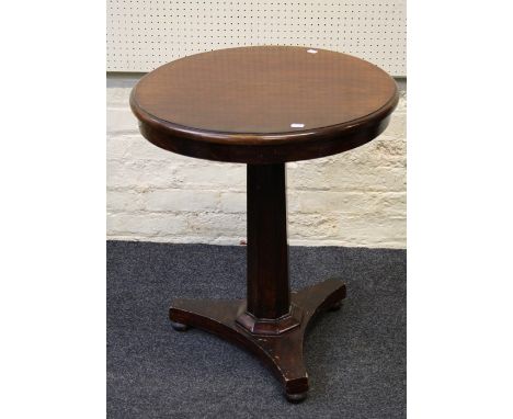 A 19th century mahogany veneer and stained lamp table, the circular tilt top on hexagonal column, concave base and bun feet. 