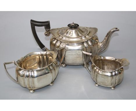 Charles Boyton and Sons, a silver three piece tea service of oval ribbed panel form, each on ball feet. Sheffield 1921/2. 38.