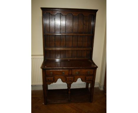 A Geo III style, reproduction oak pot-board dresser and rack fitted two short frieze and two spice drawers to the base.91cm w