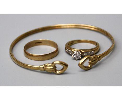 A diamond cluster ring, with diamond set shoulders, a bangle with heart-shaped terminals and a 9ct gold wedding band