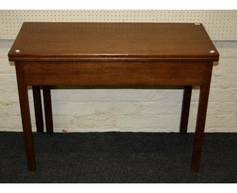 A 19th century oak supper table, the rectangular fold over top with single gate support on inner chamfered square legs. 65 x 