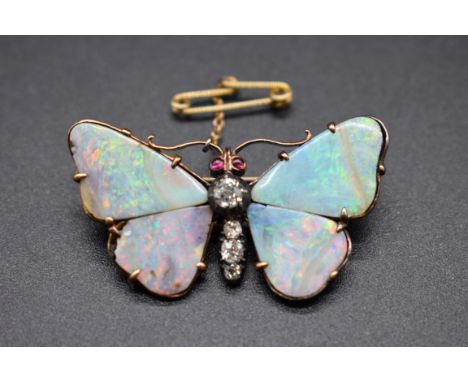 An antique yellow metal opal and diamond butterfly brooch,&nbsp;set ruby eyes, 40mm wide. 