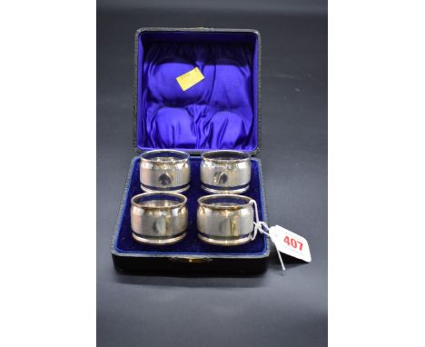 A cased set of four engine turned silver napkin rings, by George Bowen &amp; Sons, Birmingham 1928, 144g. 