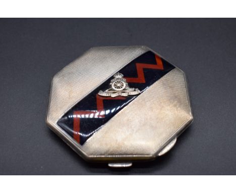 An engine turned silver and enamel powder compact, decorated Royal Artillery crest, by&nbsp;Goldsmiths &amp; Silversmiths Co 