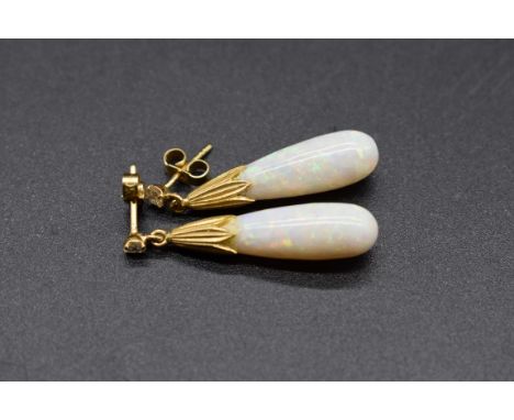 A pair of opal and diamond drop earrings, in a yellow metal setting, 33m long, both butterflies stamped '750'. 