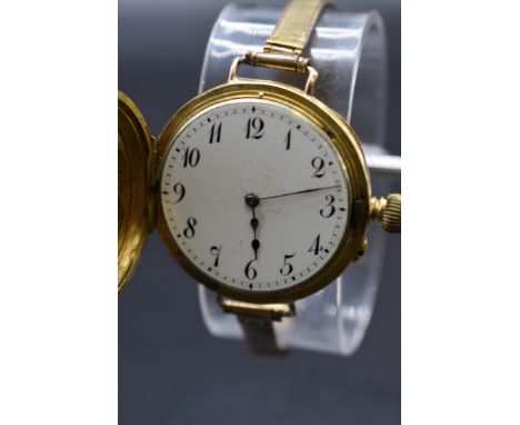 An Edwardian 18ct gold half hunter manual wind wristwatch, import mark 'B &amp; M London 1907', 35mm, on a gold plated bracel