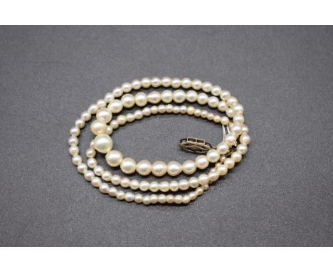 A graduated single strand pearl necklace, having white metal clasp set single diamond, stamped 9ct, 41cm. 