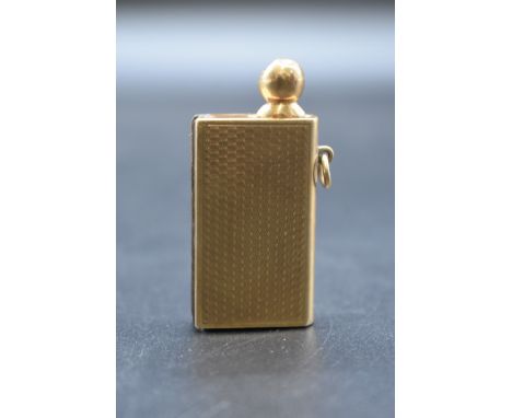An engine turned 9ct gold novelty book form strike lighter, gross weight 20g. 