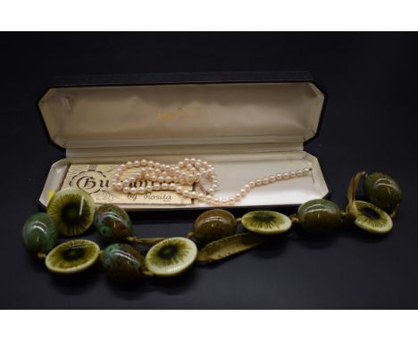 A vintage ceramic necklace,&nbsp;comprising six 'robin's egg' green mottled beads, each approx 4cm long interspersed with fiv