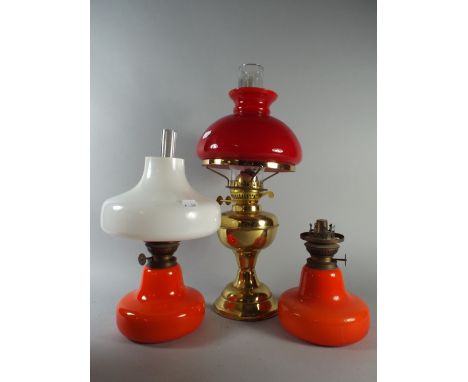 A Brass Oil Lamp and Pair of Orange Glass Oil Lamps. 