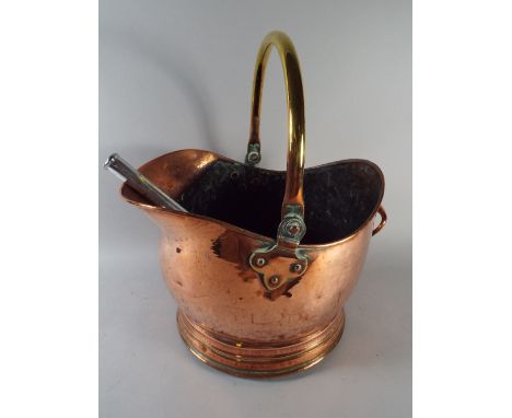 A Copper and Brass Helmet Shaped Coal Scuttle with Shovel. 