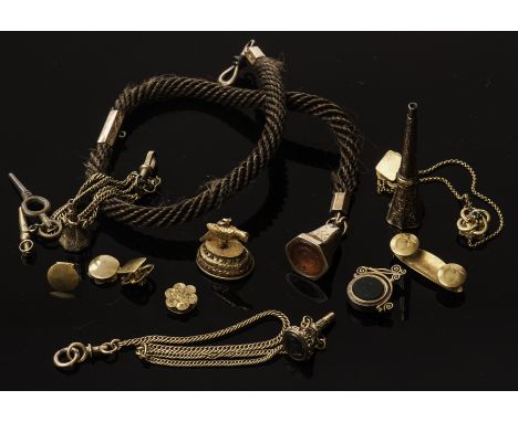 A collection of yellow metal fob seals, including a bloodstone and sardonyx fob spinner, a carnelian fob seal, three bloodsto